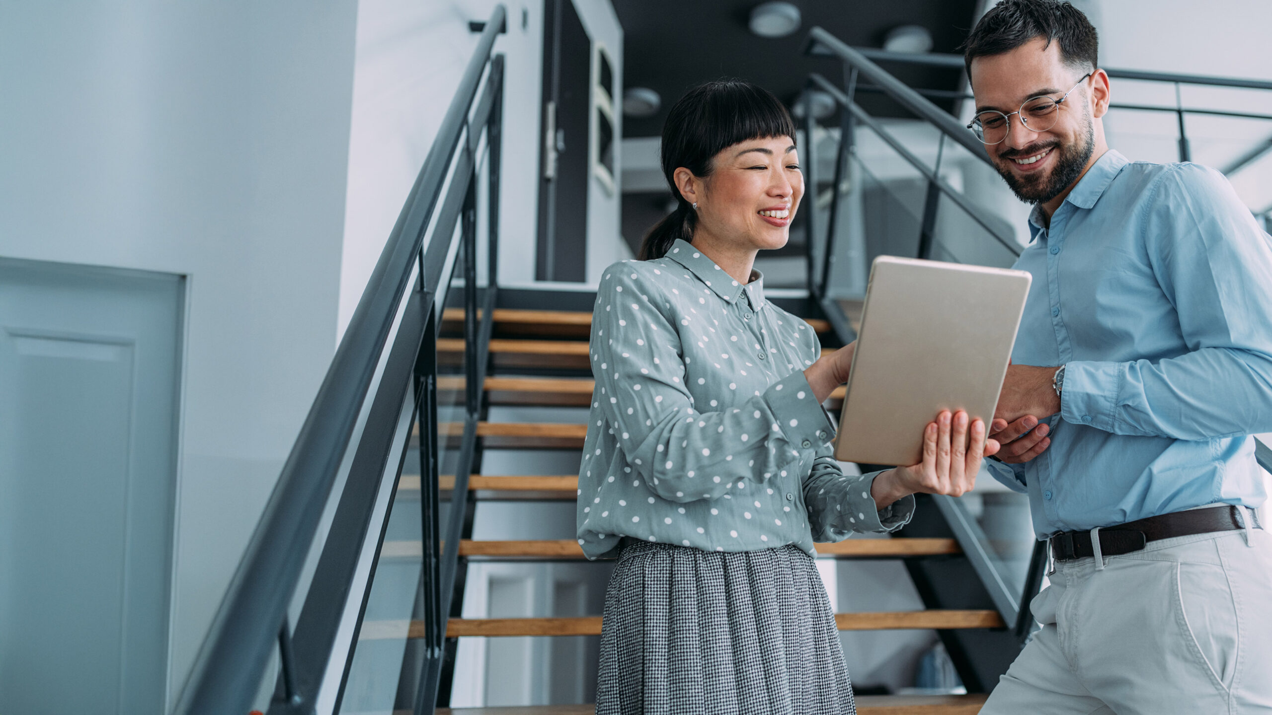 Co-workers meeting on stairs