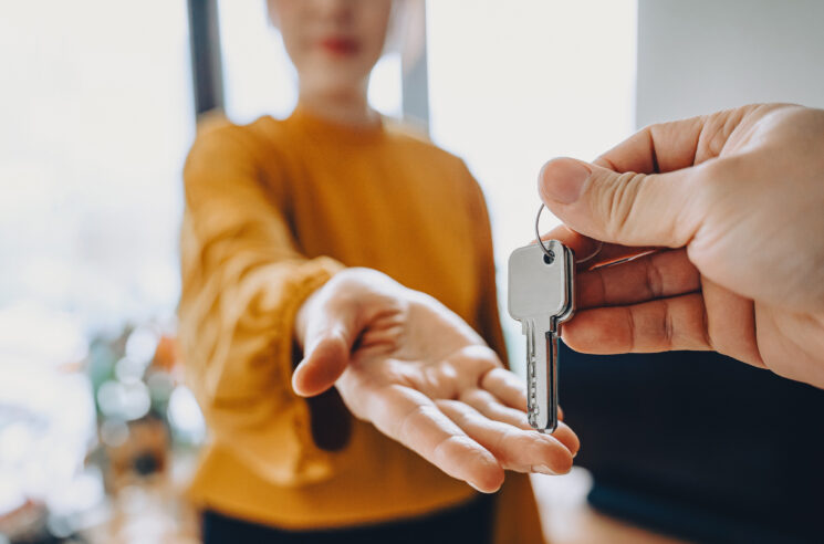 Woman being handed a set of door keys