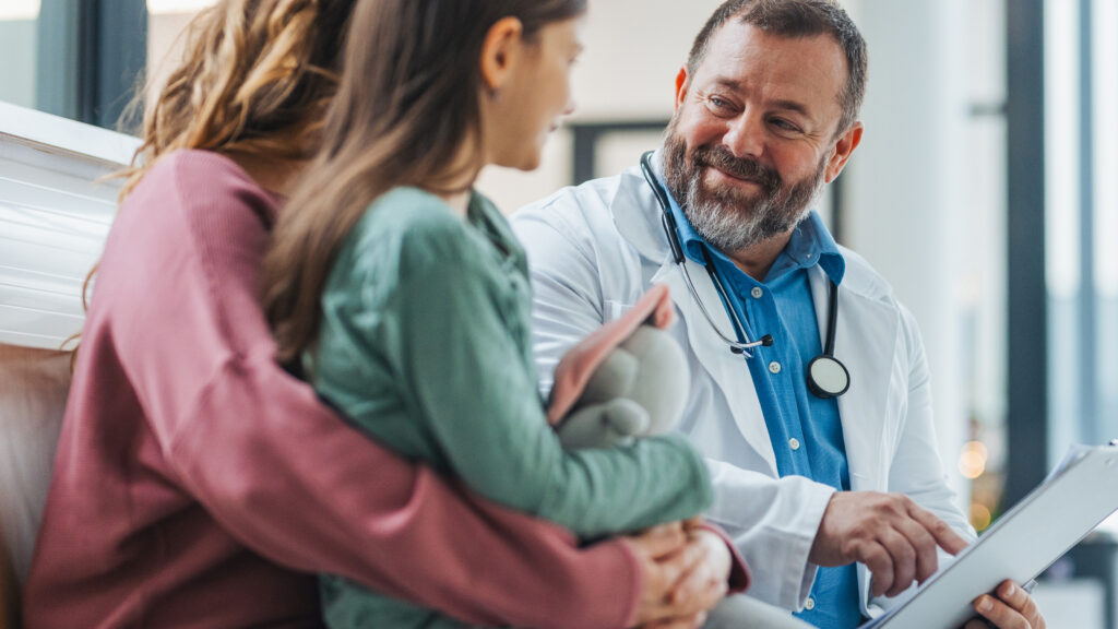 Doctor speaking with a mother and her child