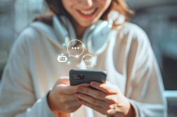 Woman on phone with dialog boxes.